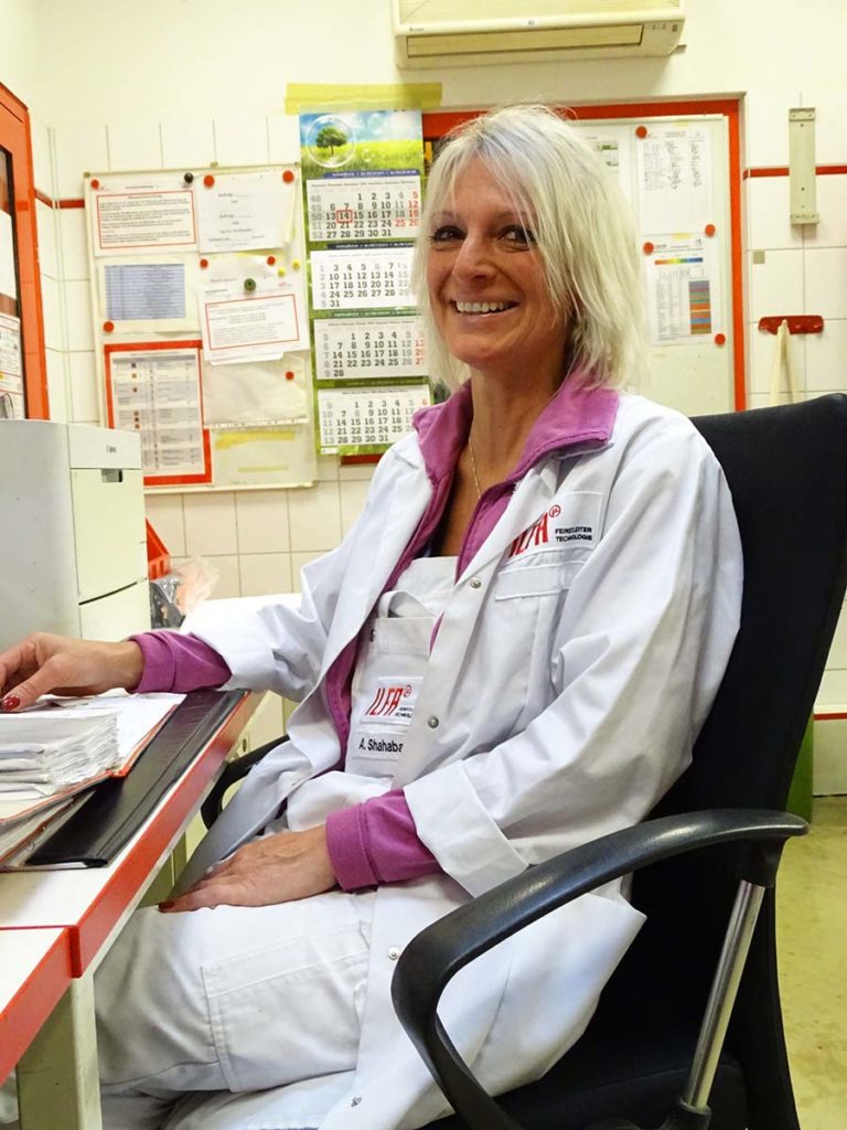 Andrea Shahabadi in the labatory, sitting at her desk